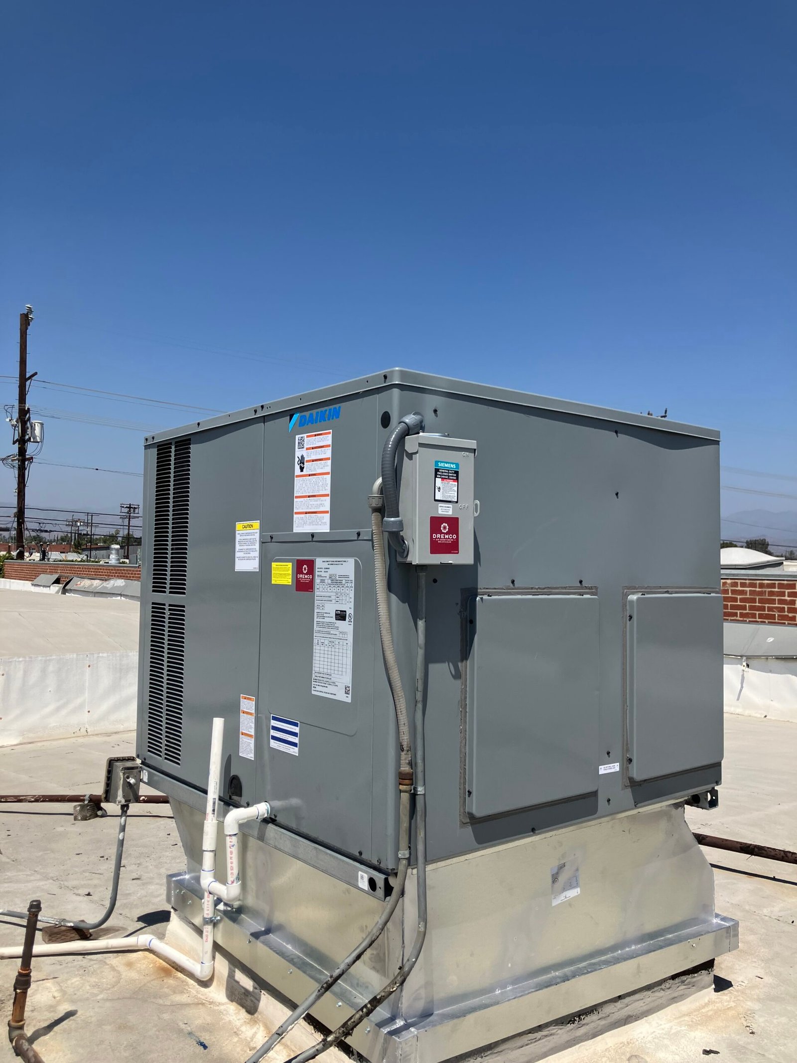HVAC installer measuring airflow and checking system connections during new central air setup